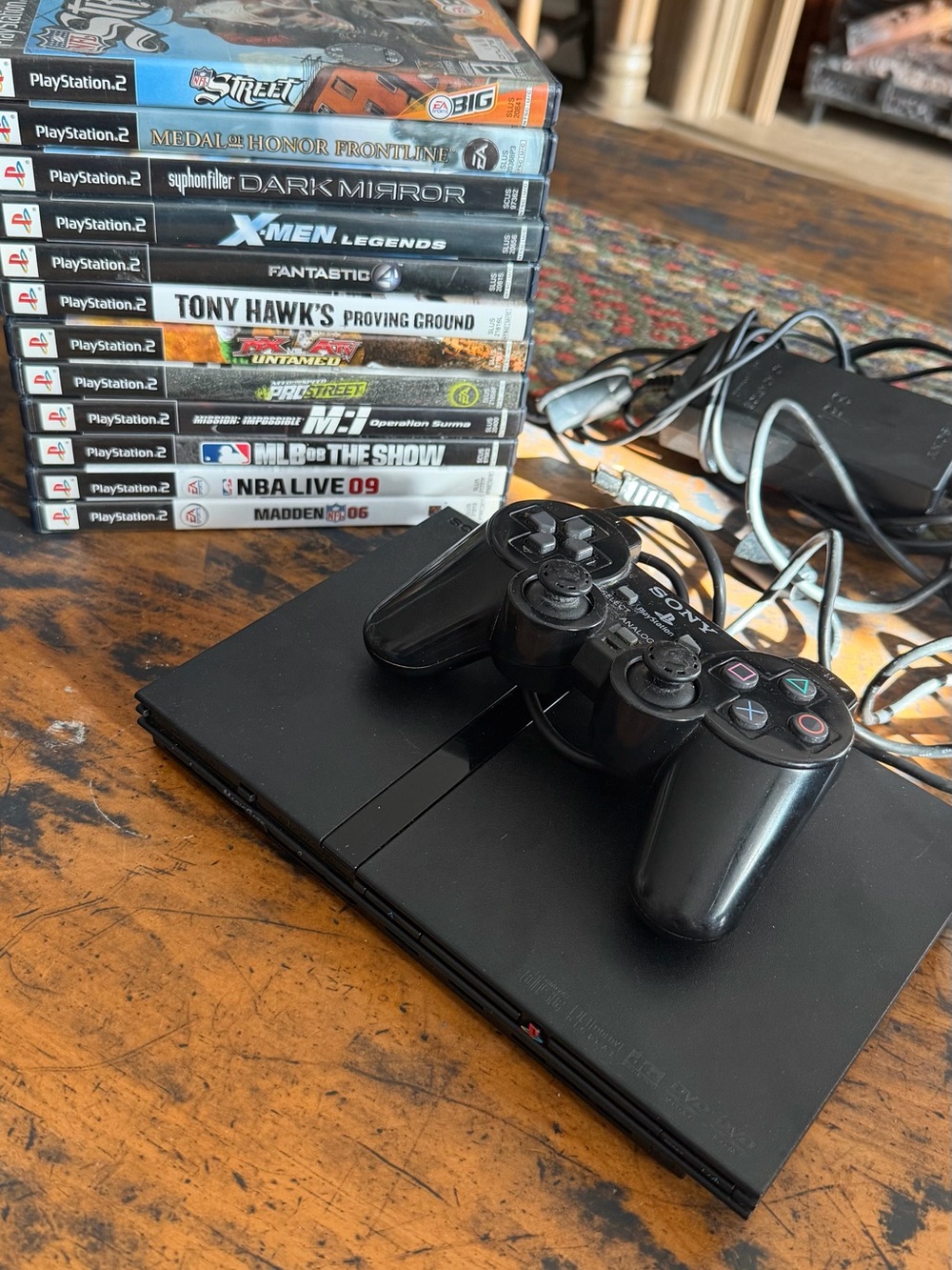 Sony PlayStation 2 Slim Console with Black Controller and Game Stack